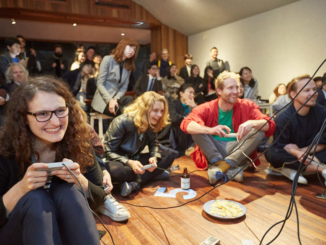 A crowd of people playing together at the 4th Shenzhen Independent Animation Biennale in China.